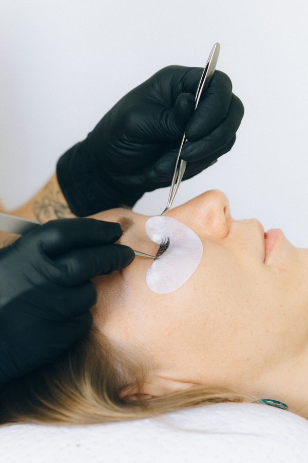Lash artist working on a client's color lash set