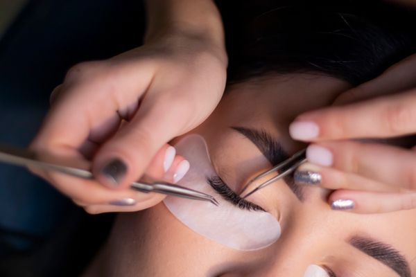 Lash artist applying premium Xtreme Lashes extensions